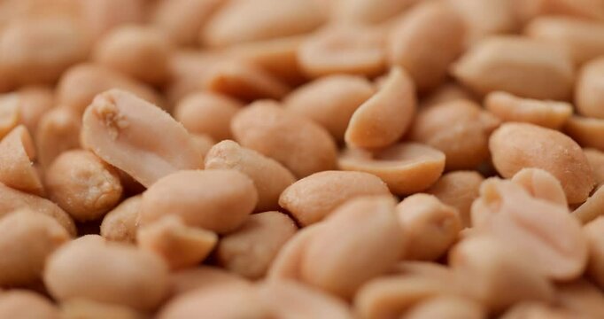 golden roasted peanuts in a detailed close-up, revealing their rich texture and Savory crunch
