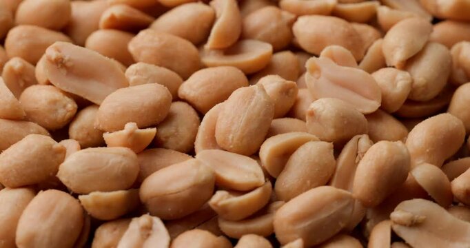 bunch of salty crunchy peanuts being captured in small detail and showing off their golden crust and being a great source of healthy fats and protein