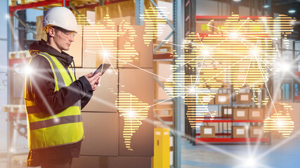 Man in warehouse delivery service. Employee international logistics company. Worker warehouse courier company. Guy monitors global supply chains. Man in yellow vest in warehouse industrial building