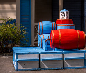 Colored barrels made of wood in the park in summer.