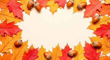 Colorful autumn leaves and acorns framing a blank space  
