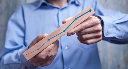 Human with a growing chart. Business