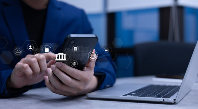 businessman hand hold smartphone and use private banking account application to using system function about checking stock market or transfer money worldwide for future tech concept