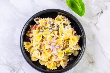 Carbonara pasta. Farfalle with pancetta, egg, parmesan cheese and cream sauce.