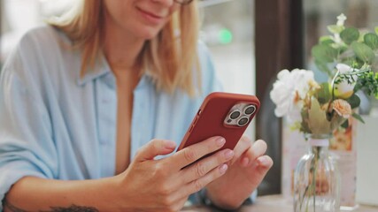 Young woman sitting at cafe, browsing smartphone while drinking coffee, embodying contemporary digital connectivity and casual urban lifestyle.Travel, tourism, food and drink. - Powered by Adobe