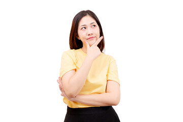 Asian young beautiful woman in a yellow shirt is standing with her hand on her chin, appearing to...