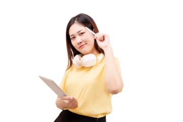 Asian young beautiful woman in a yellow shirt holds a tablet and pen, wearing headphones around her neck and smiling confidently.