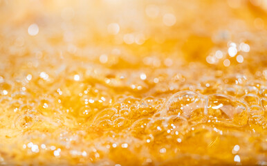 Close up bright orange Oil or beer splash texture and nature waves, Beautiful waves curve and little bubbles smooth for graphic design and background, Oil Bubbles, Soft beer bubbles, Selective focus