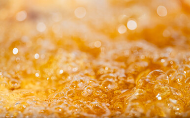 Close up bright orange Oil or beer splash texture and nature waves, Beautiful waves curve and little bubbles smooth for graphic design and background, Oil Bubbles, Soft beer bubbles, Selective focus