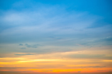 Sky,Beautiful sunset view, luxury soft gradient orange gold clouds and sunlight on the blue dramatic sky perfect for the background, morning, evening,Twilight, climate change,horizontal sunset photo