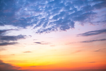 Sky,Beautiful sunset view, luxury soft gradient orange gold clouds and sunlight on the blue dramatic sky perfect for the background, morning, evening,Twilight, climate change,horizontal sunset photo
