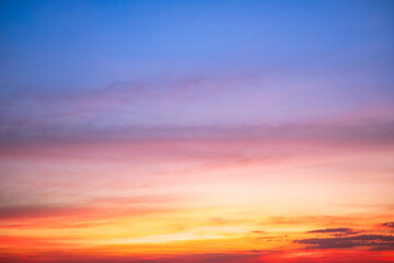 Sky,Beautiful sunset view, luxury soft gradient orange gold clouds and sunlight on the blue dramatic sky perfect for the background, morning, evening,Twilight, climate change,horizontal sunset photo