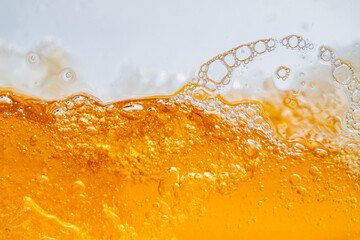 Close up bright orange Oil or beer splash texture and nature waves, Beautiful waves curve and little bubbles smooth for graphic design and background, Oil Bubbles, Soft beer bubbles, Selective focus
