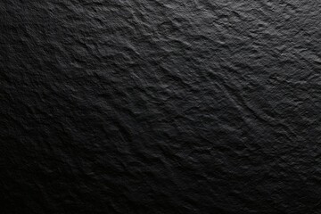 A dark and textured background, featuring rough, undulating patterns. Great for adding depth and a natural feel to designs.