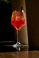 Aperol spritz cocktail with lemon and ice in a glass