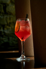 Aperol spritz cocktail with lemon and ice in a glass