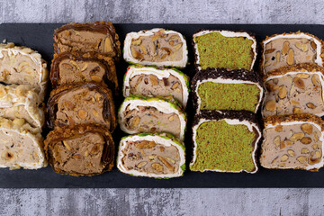 Assortment of sliced ​​Turkish delight with cream filling, pistachio, almond, hazelnut on a...