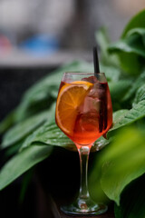 Aperol spritz cocktail with lemon and ice in a glass