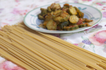 Uncooked Whole Wheat Spaghetti on Floral Tablecloth