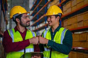 Blue collar workers are working at warehouse.