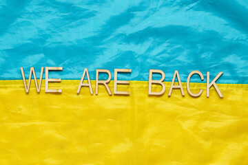 Flag of Ukraine with the inscription We are back, symbol of the return of captured heroes home to...