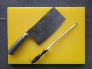knife on a yellow and red cutting board