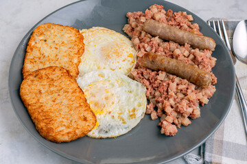 eggs ove easy  with corn beef hash and sausage
