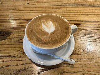 Beautifully crafted latte, complete with a heart design, ready to be savored at the cafe.