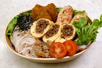 A traditional Korean dosirak, beautifully arranged with rice, assorted banchan, and savory proteins. Balanced and visually inviting, it’s a portable meal packed with vibrant flavors.