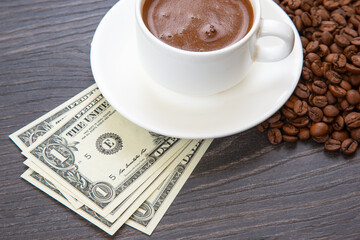 Enjoying a rich cup of coffee with fresh beans and a touch of cash on a wooden table. coffee business