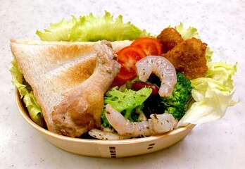 A traditional Korean dosirak, beautifully arranged with rice, assorted banchan, and savory proteins. Balanced and visually inviting, it’s a portable meal packed with vibrant flavors.
