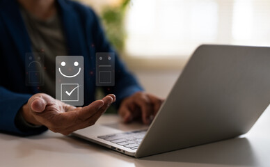 A man give rating to service experience on online application, use laptop, Evaluate quality of service leading to reputation ranking of business. Customer review satisfaction feedback survey concepts