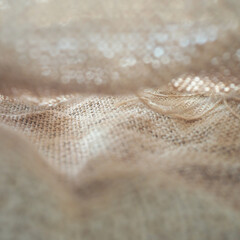 Abstract soft mesh fabric, surface showing weave and motion. Ideal for textile-based graphic