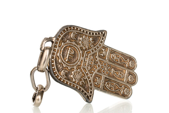 One metal keychain, Jewish "hand of Miriam", close-up, isolated on white.