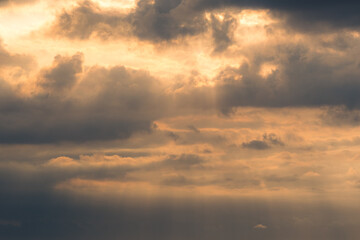 Golden Sunset Sky with Sun Rays Breaking Through Clouds