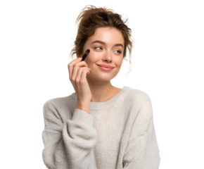 Attractive young woman applying eye makeup, smiling while enjoying her beauty routine.