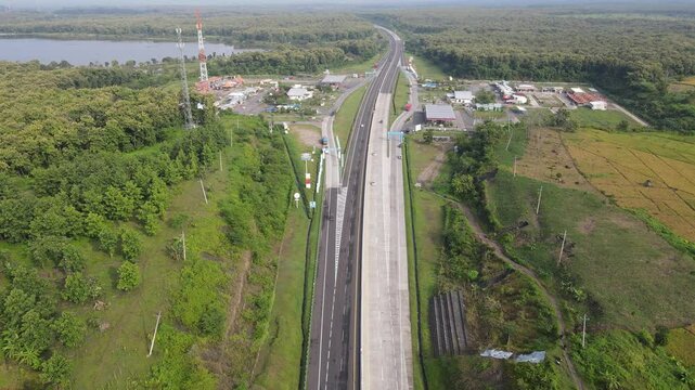 Aerial view of a rest area in Ngawi, East Java, with toll road and rice field.