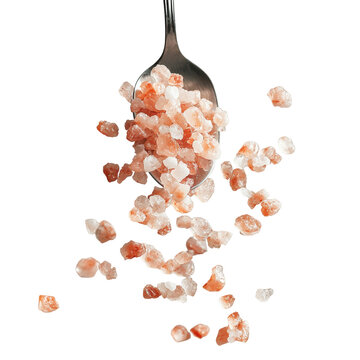 A tablespoon of pink Himalayan salt crystals spilling mid-air, clean white background