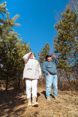 Fototapeta premium Romantic and elderly healthy lifestyle concept. Senior active Caucasian couple holding hands looks happy in park in autumn forest,happy anniversary,happily retired married couple together