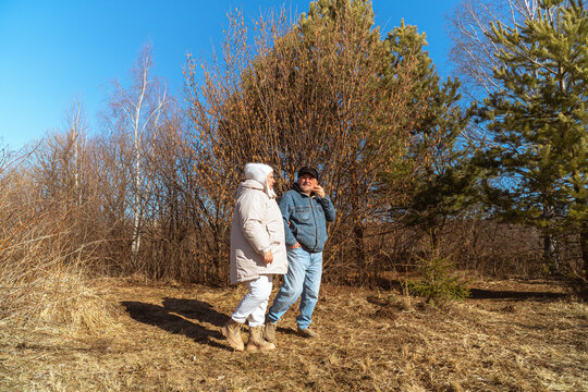 Romantic and elderly healthy lifestyle concept. Senior active Caucasian couple holding hands looks happy in park in autumn forest,happy anniversary,happily retired married couple together