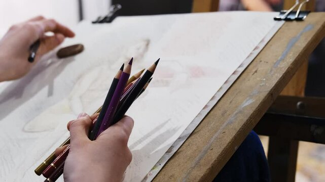 Artist uses special colored pencils techniques to create figure. Professional draws mannequin and finalises details sitting in creative studio