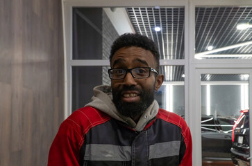 Smiling cheerful adult african american ethnicity man with a beard looking at camera. A happy...