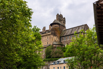 Castle of Estaing on a cloudy day from the banks of the Coussane River