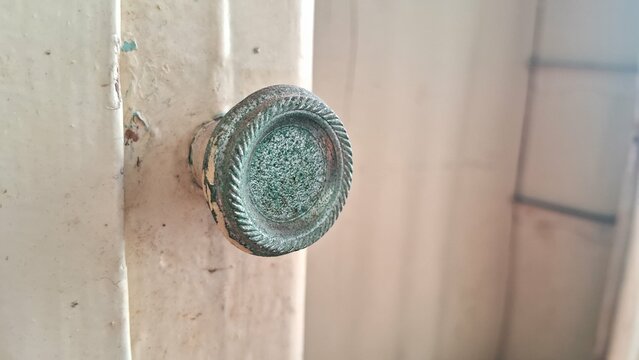 Old wooden door with green handle