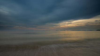 A tranquil sunset sea with beautiful sunlight reflecting over the sea surface.