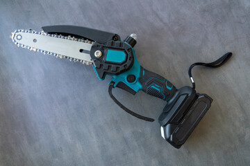 Cordless chain saw top view.A tool for cutting branches.