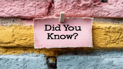 Interesting fact displayed on wall featuring brickwork paper and clothespin and question