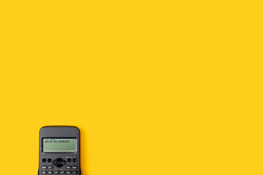 Calculator on the yellow background. Back to school flat lay. - Powered by Adobe