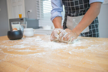 Professional chefs sift flour and sprinkle ingredients onto dough for baking.