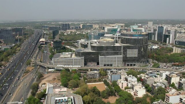 Drone Shot of DLF Cyber City Gurgaon &ndash; Aerial View of Iconic IT Hub with Glass Towers, Office Buildings, Skywalk, Metro Line, and Modern Infrastructure in Gurugram, India